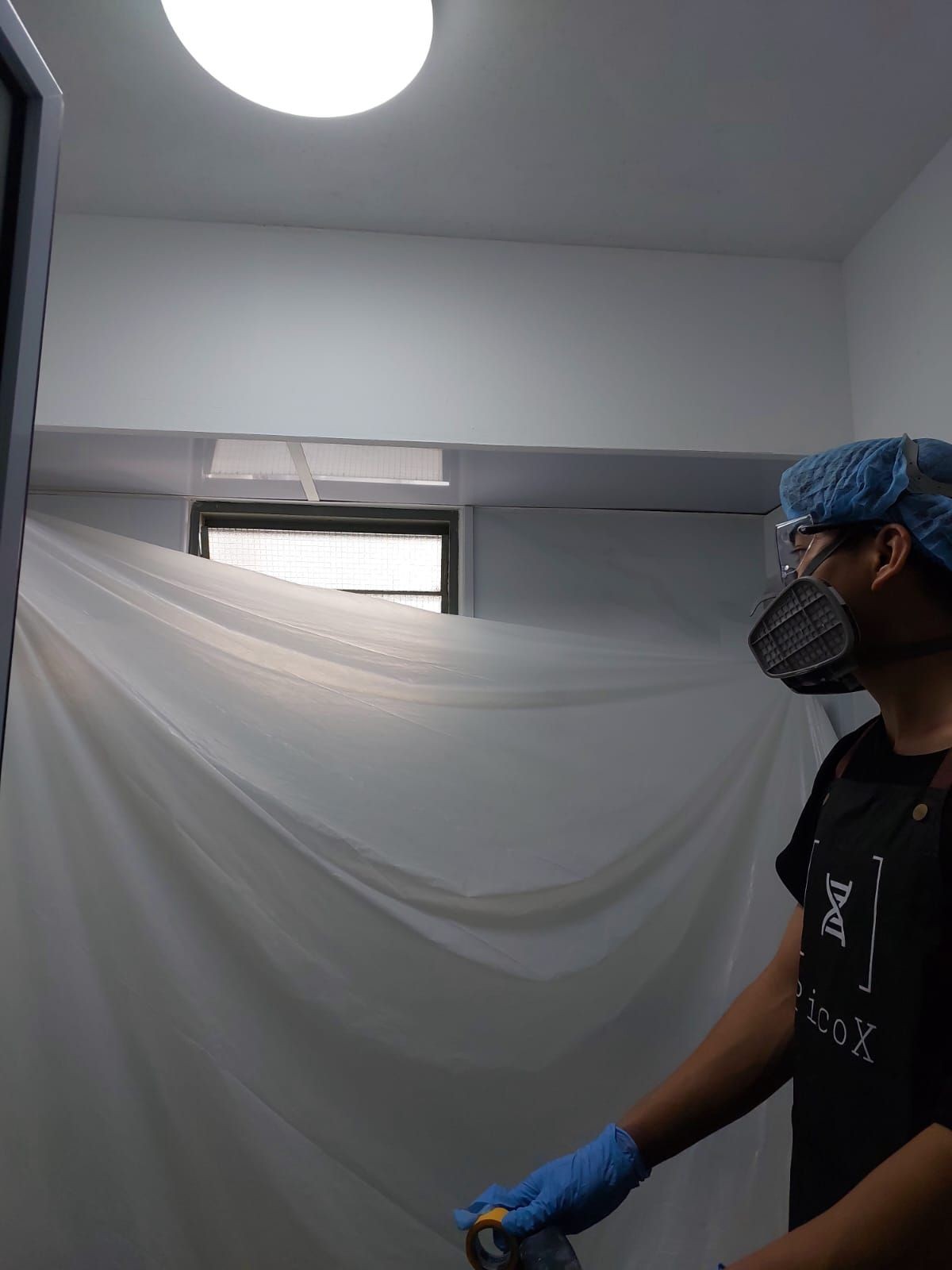 Pico X Health team rolling a feature wall in a Singapore home